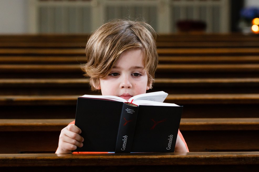 Kommunionkind mit Gotteslob