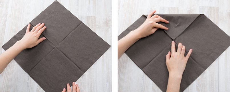 Braune Serviette wird zur Mitte hin gefaltet.